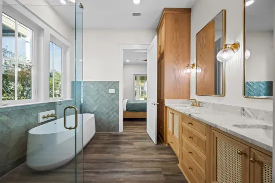 Soak away the beach sand in the freestanding tub, then rinse off in the walk-in shower — this ensuite was built for unwinding, not rushing.