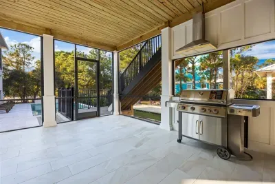 Fire up the built-in grill on the screened patio — no propane tank runs, just step outside and start cooking with the pool in view.