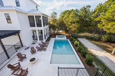 See the whole layout from above — pool, spa, fire bowl, and porches all within a few steps of each other.