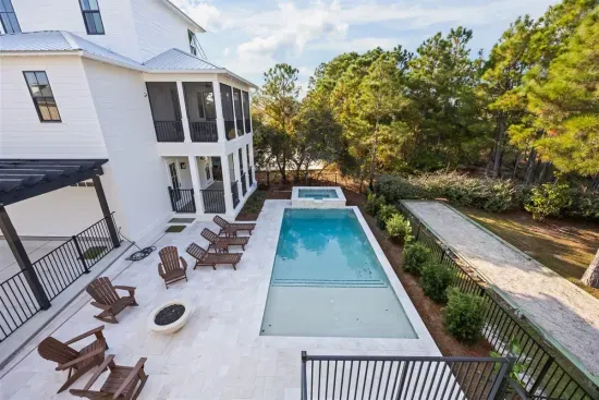 See the whole layout from above — pool, spa, fire bowl, and porches all within a few steps of each other.