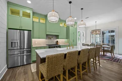 Pull up a seagrass stool at the island and pour your coffee while the group trickles in — this kitchen is built for gathering, not just cooking.