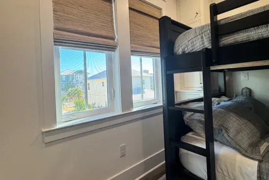 Raise the shades in the morning to palm tree tops and big sky — even the bunk room gets a view here.