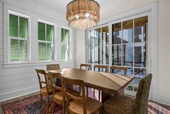 Linger over dinner in the dining room, chandelier glowing overhead, with sliding glass doors opening straight onto the screened porch.