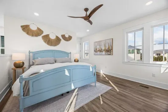Retreat to the guest house's own primary suite, woven wall accents overhead and a rooftop view through the window.