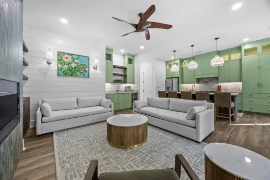 Sink into one of two sofas, including a queen sleeper, or the cozy accent chair — the living room opens straight into the kitchen so no one's ever far from the action.
