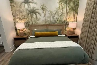 Escape to this downstairs king suite for the night, a jungle mural spanning the wall behind you like your own tropical hideaway.