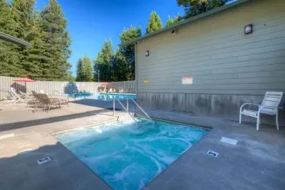 Relax by the outdoor pool and bubbling hot tub under sunny mountain skies