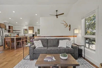 Bright open living room with cozy seating and a stylish kitchen bar