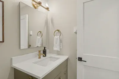 Bright modern bathroom with sleek vanity and elegant gold finishes