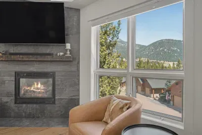 Cozy fireside lounge with mountain views and bright picture windows