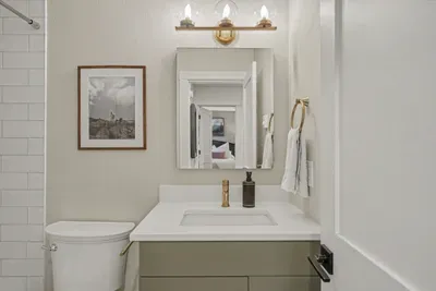 Modern bathroom with brass accents and a bright, polished design