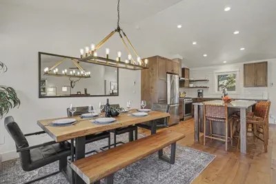 Bright open dining space with farmhouse table and modern kitchen island