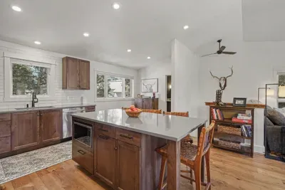 Bright modern kitchen with island seating and warm wood finishes