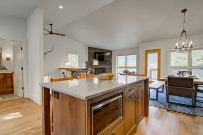 Cook dinner and catch the game or your favorite movie on the big screen while the kiddos play monopoly at the dining table. 