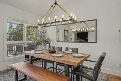 Bright dining space with forest views and stylish modern lighting