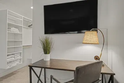 Dedicated workspace with TV and spacious walk-in closet