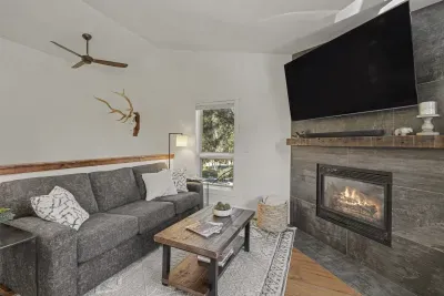 Cozy modern living room with fireplace, big TV, and rustic charm