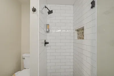 Bright modern walk-in shower with subway tile and sleek finishes