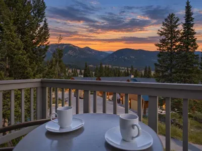 Private balcony with coffee and stunning mountain sunset views