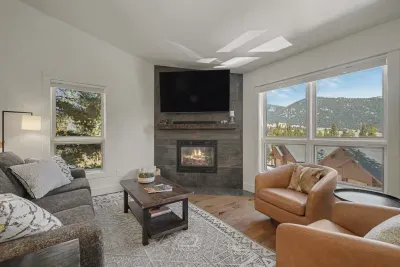 Cozy mountain-view living room with fireplace and big picture windows