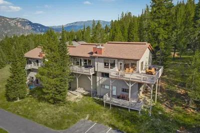 Secluded mountain retreat with forest views and spacious outdoor decks