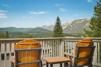 Private mountain-view deck with Adirondack chairs and stunning alpine scenery