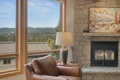 Cozy fireside lounge with sweeping mountain views through picture windows