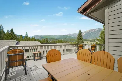 Mountain-view deck with outdoor dining and scenic alpine seating