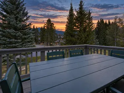 Private mountain-view deck with outdoor dining and stunning sunset skies