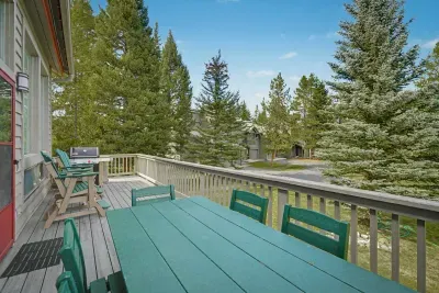 Spacious treetop deck with outdoor dining, grill, and serene forest views