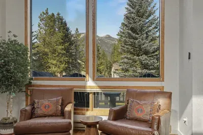 Sunny reading nook with leather chairs and stunning mountain views