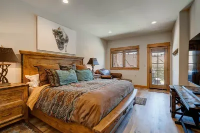 Master Bedroom: Natural wood accents and plush seating create a serene retreat with stunning views!