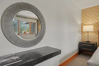 Stylish bedroom nook with accent wall, modern decor, and scenic views