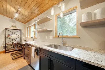 Fully stocked kitchen with stainless steel appliances.