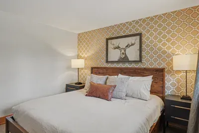Cozy king bedroom with rustic accents and warm bedside lighting