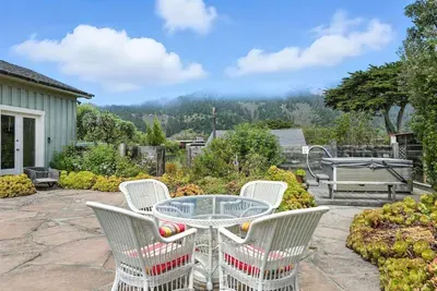 - Patio dining area with mountain views and beautiful garden surroundings  - Glass top table with cushioned chairs offers comfort for outdoor meals  - Peaceful retreat perfect for enjoying the natural scenery and fresh air