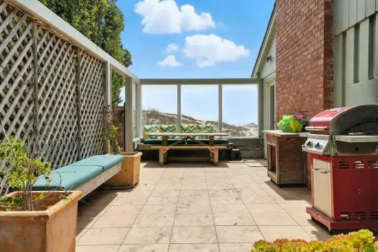 - Spacious patio with BBQ grill, built in benches, and shaded lounge area  - Enclosed design offers privacy while still enjoying ocean views nearby  - Great for outdoor meals, family gatherings, or relaxed afternoons