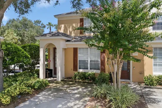 Front exterior of a two story villa with beautiful landscaping.