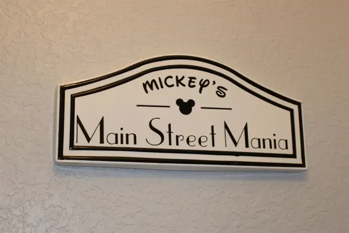 - Mickey’s Main Street Mania sign sets the tone for a fun filled Disney getaway  
- Adds a cheerful welcome for guests upon entering this themed retreat  
- Creates a sense of excitement for the magical stay ahead