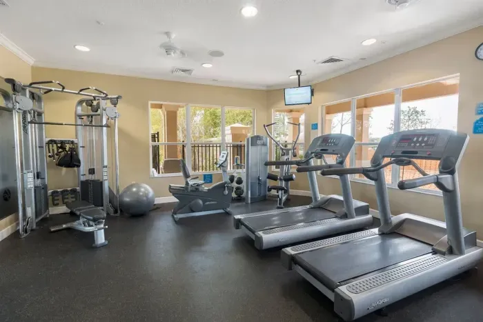 Fitness center with treadmills, machines, and free weights.