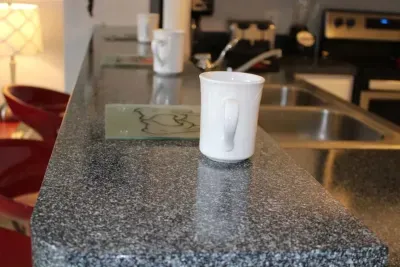 - Breakfast bar with granite countertop and white mugs ready for morning coffee  
- Sleek double sink and modern fixtures for style and convenience  
- Perfect for quick snacks or casual meals while chatting with friends and family