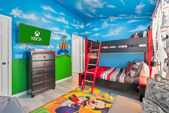- Disney themed bedroom with vibrant murals, bunk beds, and wall mounted TV  
- Colorful rug and playful decor create a fun, immersive space for kids  
- Ideal for rest and play with plenty of room for young guests to enjoy