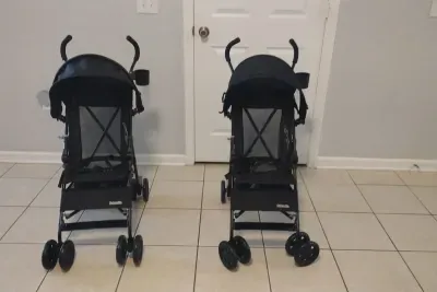 Two lightweight strollers ready for guest use.