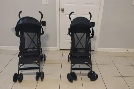 Two lightweight strollers ready for guest use.
