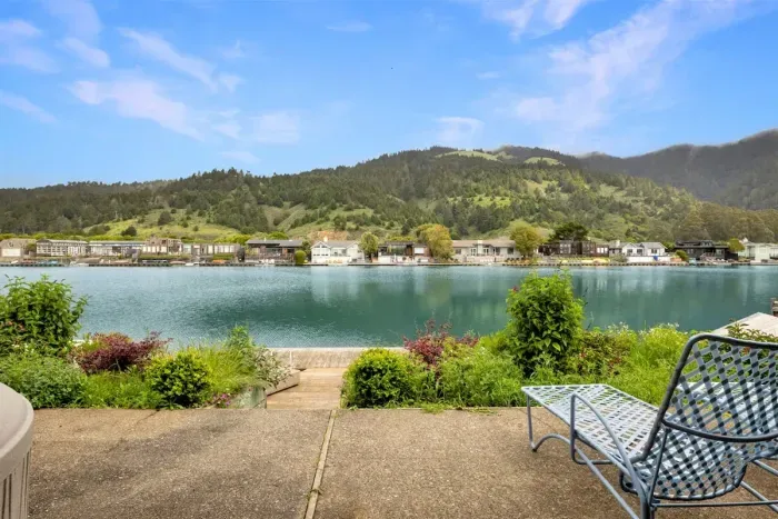 Patio seating with serene lake and mountain views.
