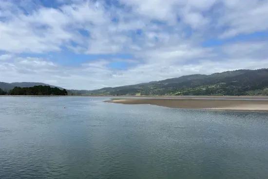 Stylish water views with rolling hills in the distance.