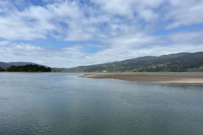 Stylish water views with rolling hills in the distance.