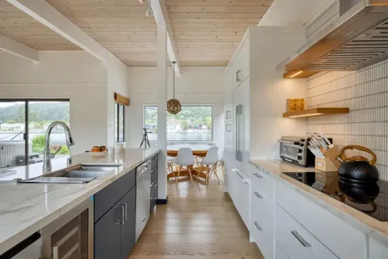 - Modern kitchen with marble countertops and sleek cabinetry for style  
- Open layout flows into dining area with natural light from large windows  
- Fully equipped with premium appliances for an elevated cooking experience