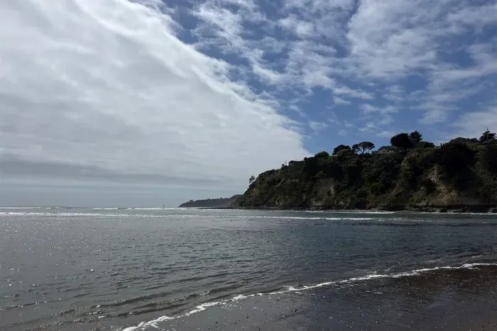 Scenic ocean view from the shoreline at the cliff base.
