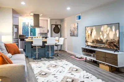 - Open plan living area seamlessly connecting kitchen, dining, & lounging zones
- Plush seating faces a flat screen TV for relaxing movie nights or casual viewing
- Island seating doubles as a spot for morning coffee or lively evening conversation